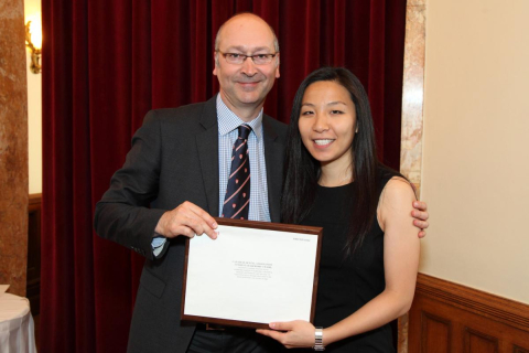 Kristina with Dean Allison receiving an award at graduation