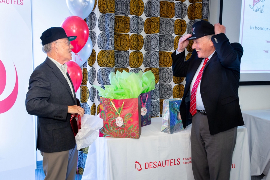 Henry Mintzberg and Morty Yalovsky try on their gifted caps. 