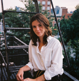 Margaret Meehan seated on a porch 