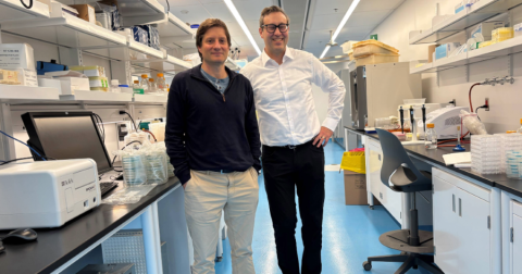 two men standing in a lab
