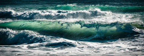 Turquoise waves rising and falling together