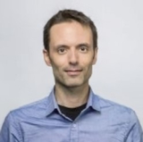 Marc-Etienne Rousseau looking at camera and smiling, wearing a light blue shirt