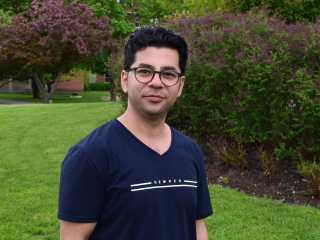 Emal Sabot PhD researcher on AGGP project, stands outside, spring 2019