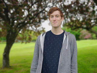 Liam Fitzpatrick, MSc student on the AGGP stands outside in spring, 2019