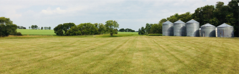 ECP3 Home Page - Mowed hayfield and grain silos in background