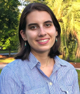 smiling lady wearing a blue and white striped shirt