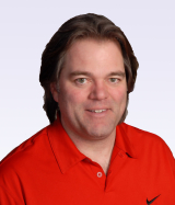 man posing for camera wearing a red tshirt