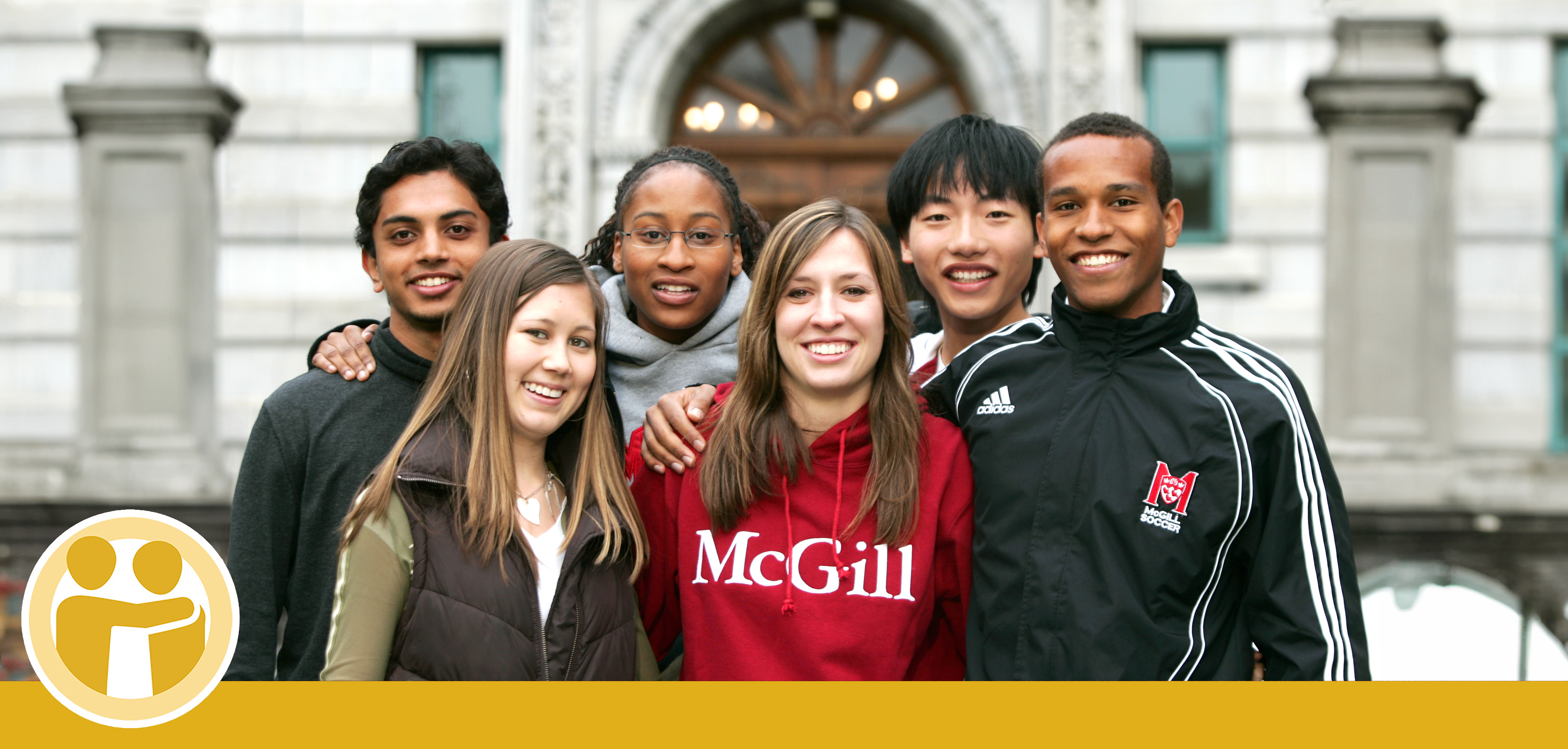 McGill students gather in front of the Arts Building. One student is wearing a McGill sweatshirt.