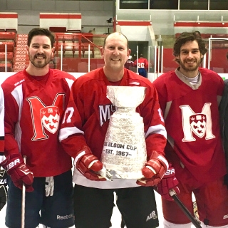 Dr. Gordon Bloom with hockey players and the Bloom Cup