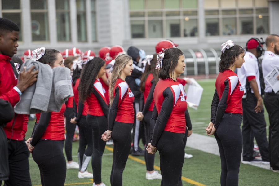 Cheer Squad Stand at Attention in black and red on the field at Molson Stadium