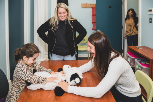 Grad students with with a small child in the lab