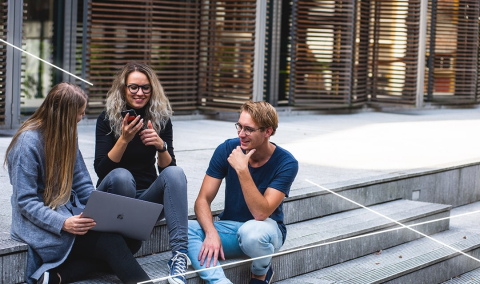 Students sitting on steps and chatting with one another