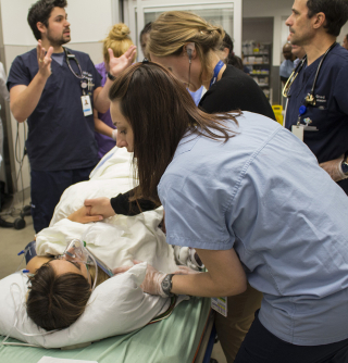 Doctors and nurses care for a simulated patient