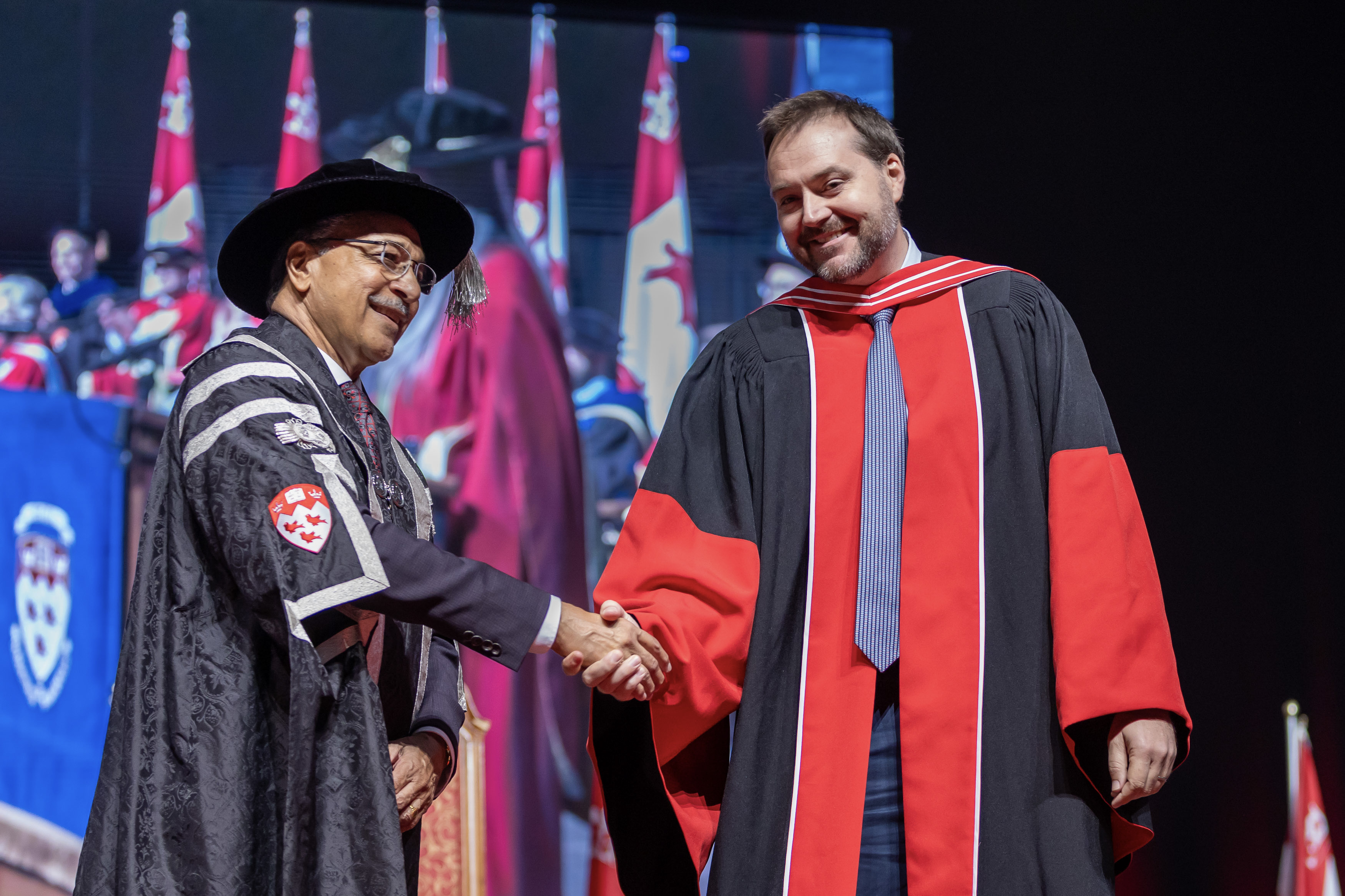 President Saini shakes hands with Teaching Award recipient James Forbes at Spring 2024 Convocatoin