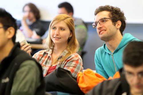 2 students engaging in a conversation in the classroom