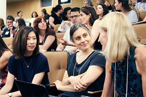 3 women having an engaging conversation in a conference room