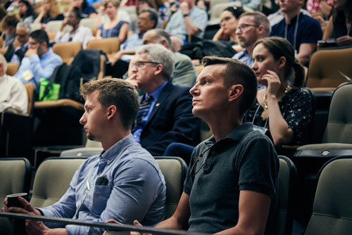 a group of people sitting in a lecture hall