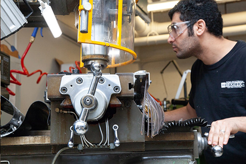 a man working on a cutting machine