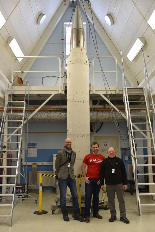 Left to right: Andrew Higgins (Professor of Mechanical Engineering), Jan Palecka (PhD student in Mechanical Engineering), Samuel Goroshin (Research scientist in Mechanical Engineering) smiling in front of a rocket