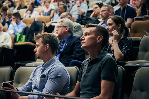 people in an auditorium listening attentively to the speaker