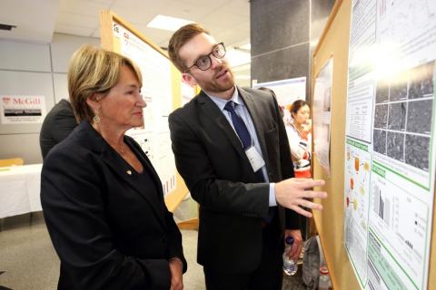 A student explaining McGill Engineering Research Showcase to Principal Suzanne Fortier