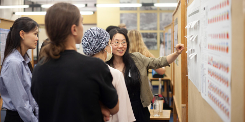 a student presenting her research in front of a group