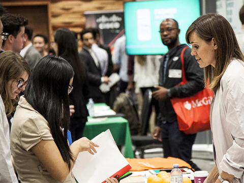 Students having discussion in group at the McGill TechFair company booths