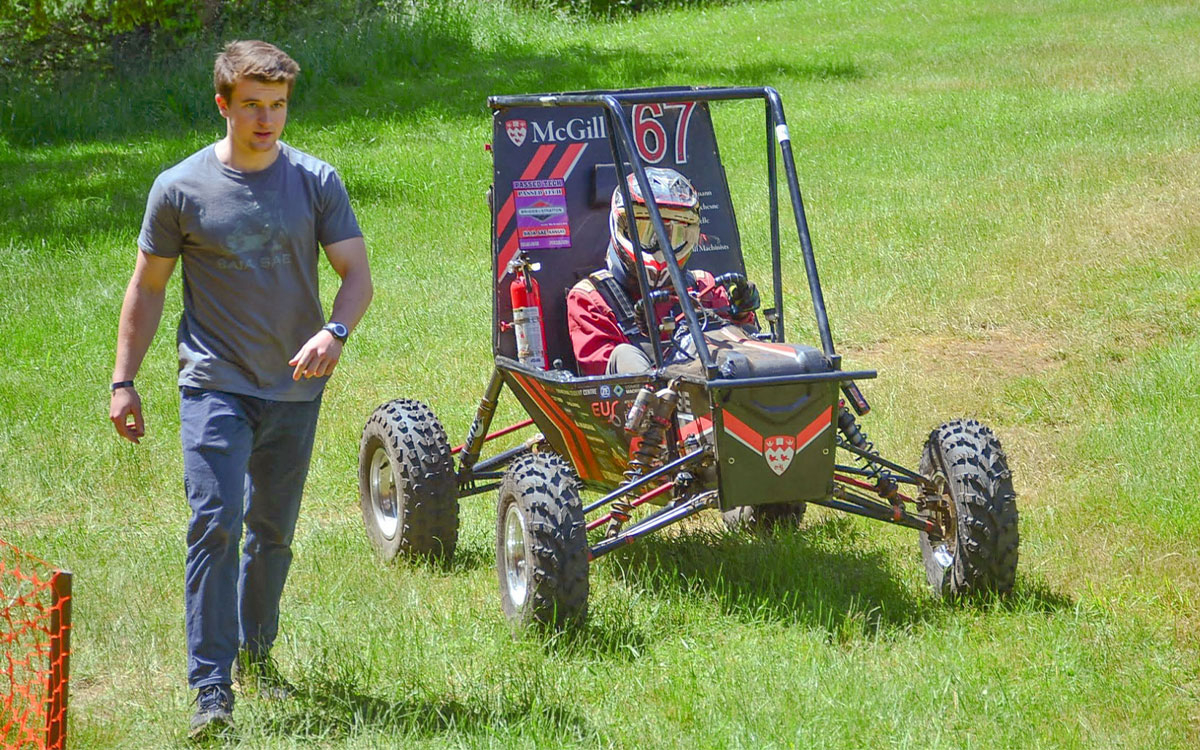 Mark McGriskin walking next to a baja vehicle