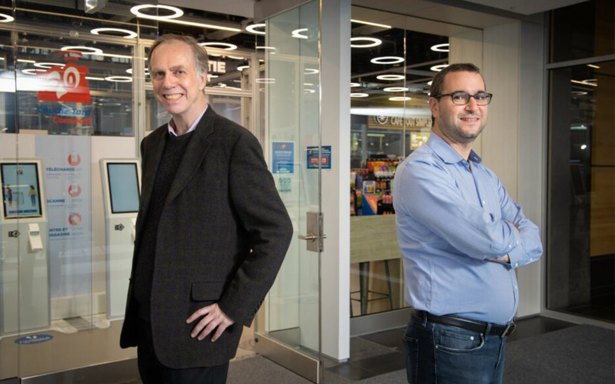 Professor James Clark and Associate Professor Maxime Cohen in front of Couche-Tard frictionless laboratory store