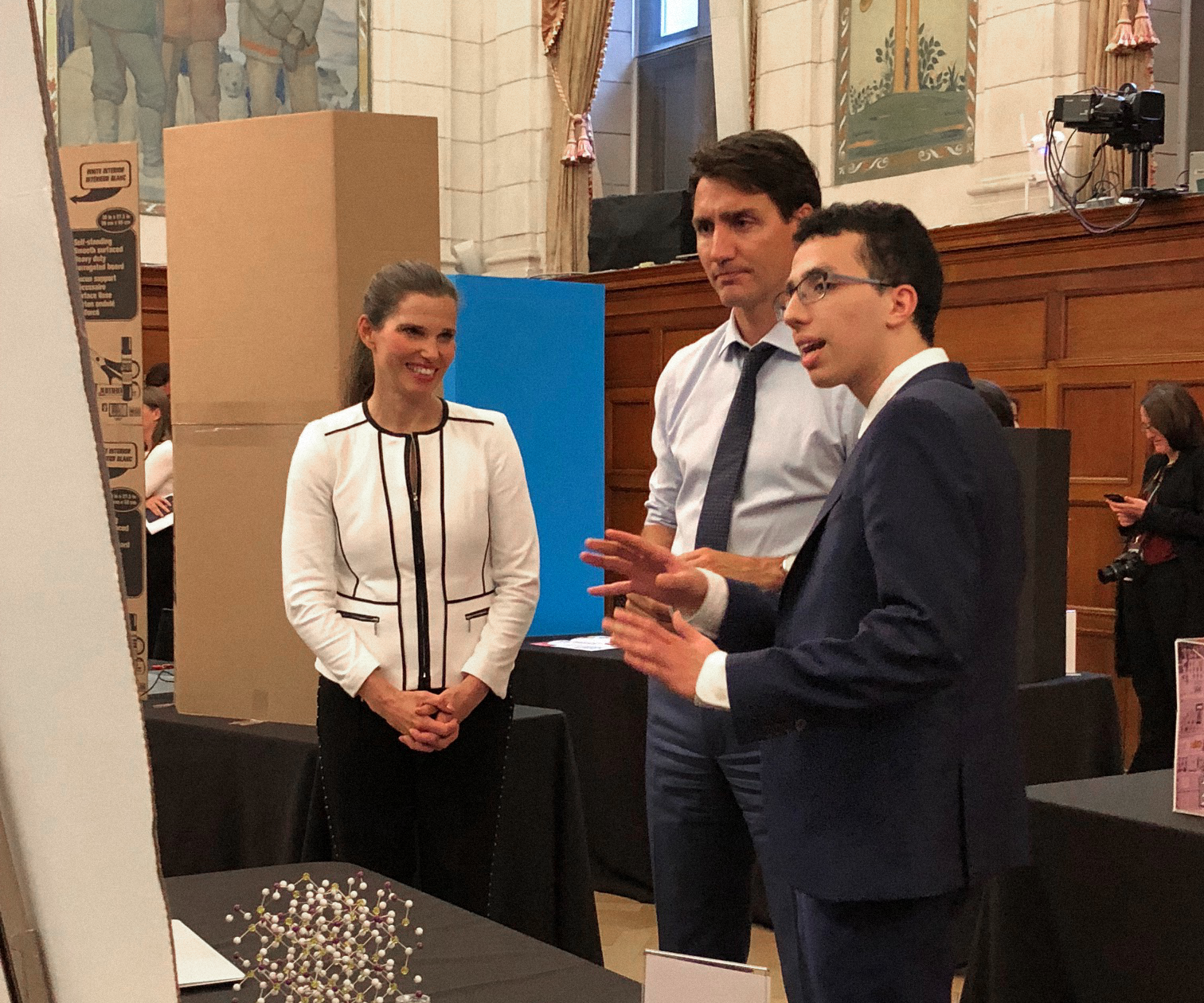 Kenz Zaghib, a first-year Faculty of Engineering student explaining science fair project to Prime Minister Justin Trudeau and another woman