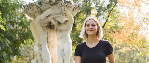 Tara Allen-Flanagan on campus in front of statue