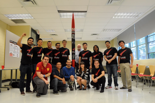 Group of McGill Rocket Team members posing with a rocket