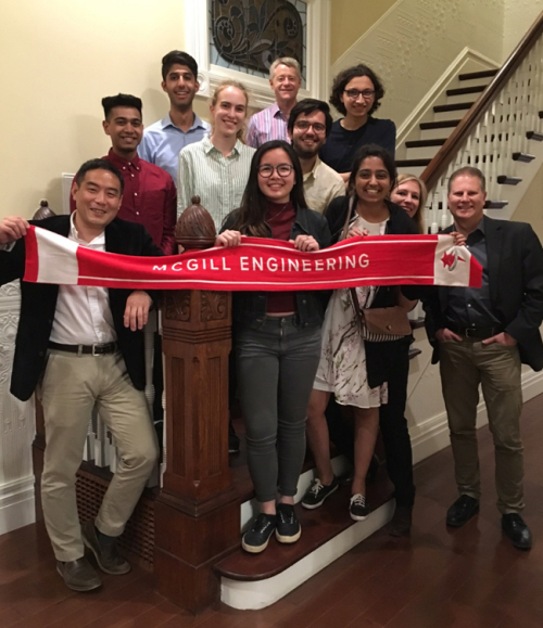 Group of people smiling while holding a banner that bears McGill Engineering name