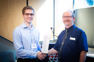 2018 SURE Faculty Prize winner Brennan Nichyporuk, Department of Software Engineering, posing for photo with presenter