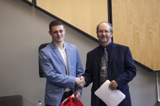 2017 SURE Faculty Prize winner Nikita Kalashnikov, Department of Chemical Engineering, posing for photo with presenter