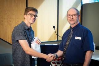 2018 SURE Faculty Prize winner Corey Miles, posing for photo with presenter