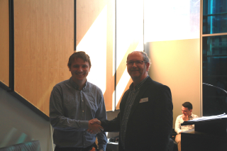2019 SURE Faculty Prize winner Peter Wilk, Department of Mechanical Engineering, posing for photo with presenter