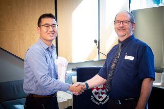 2018 SURE Faculty Prize winner Yuanzhe Gong, Department of Electrical Engineering, posing for photo with presenter