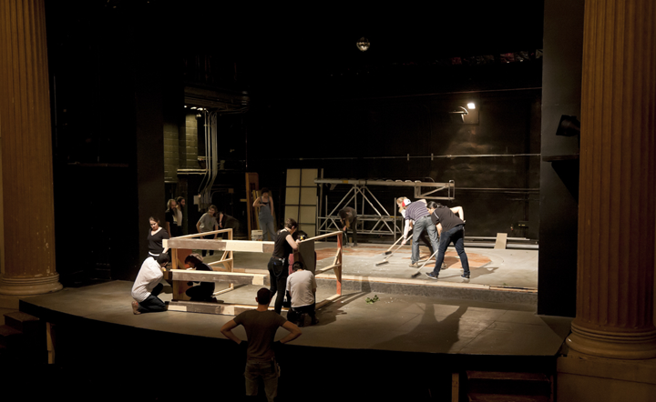 Students building a set on stage
