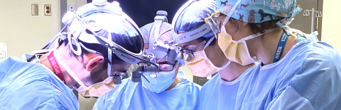 Closeup of four surgeons in the operating theatre