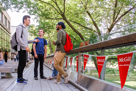 Group of young men talking on campus