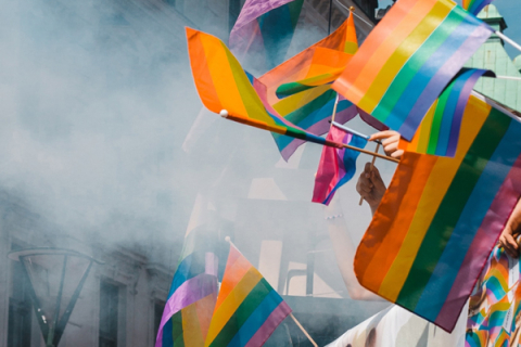 Rainbow flags waving at a parade