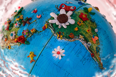 Globe with South American continent visible with fun ornaments placed in various areas