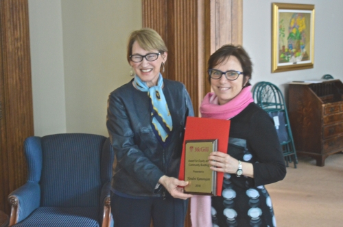 Principal and Vice-chancellor Fortier and Véronique Bélanger accepting the award on behalf of Prof. Nandini Ramanujam