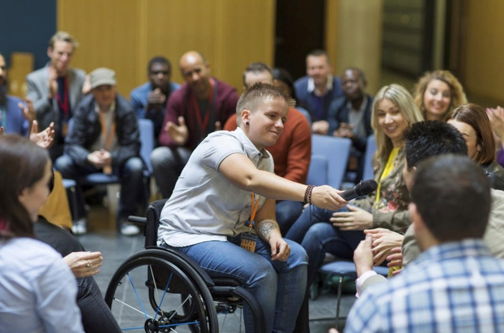 A student in a wheelchair participating in a group discussion.