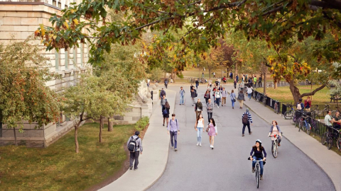 Downtown campus road in summer with people walking and cycling