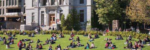 Lawn in front of Redpath Museum filled with people sitting on the grass
