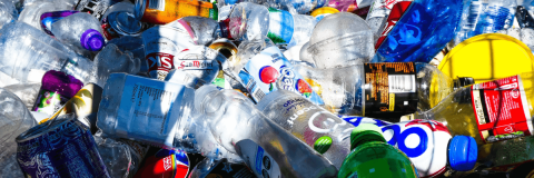 Numerous empty plastic bottles and cans piled together