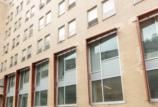 Building façade with large windows on the lower floors.
