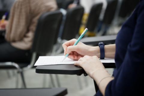Student at a desk writing an exam